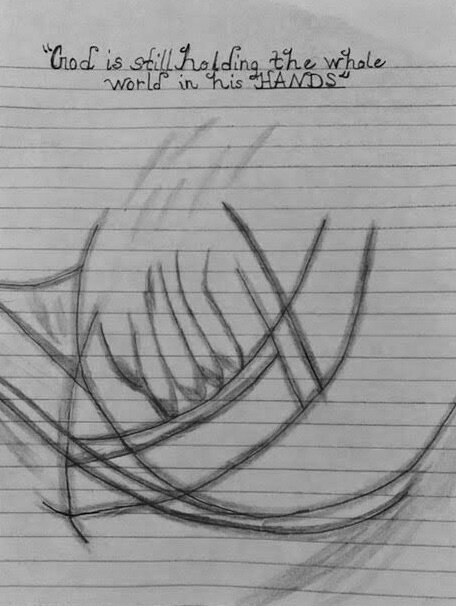 A drawing by one of Carrie’s children, with the inscription “God is still holding the world in his HANDS“