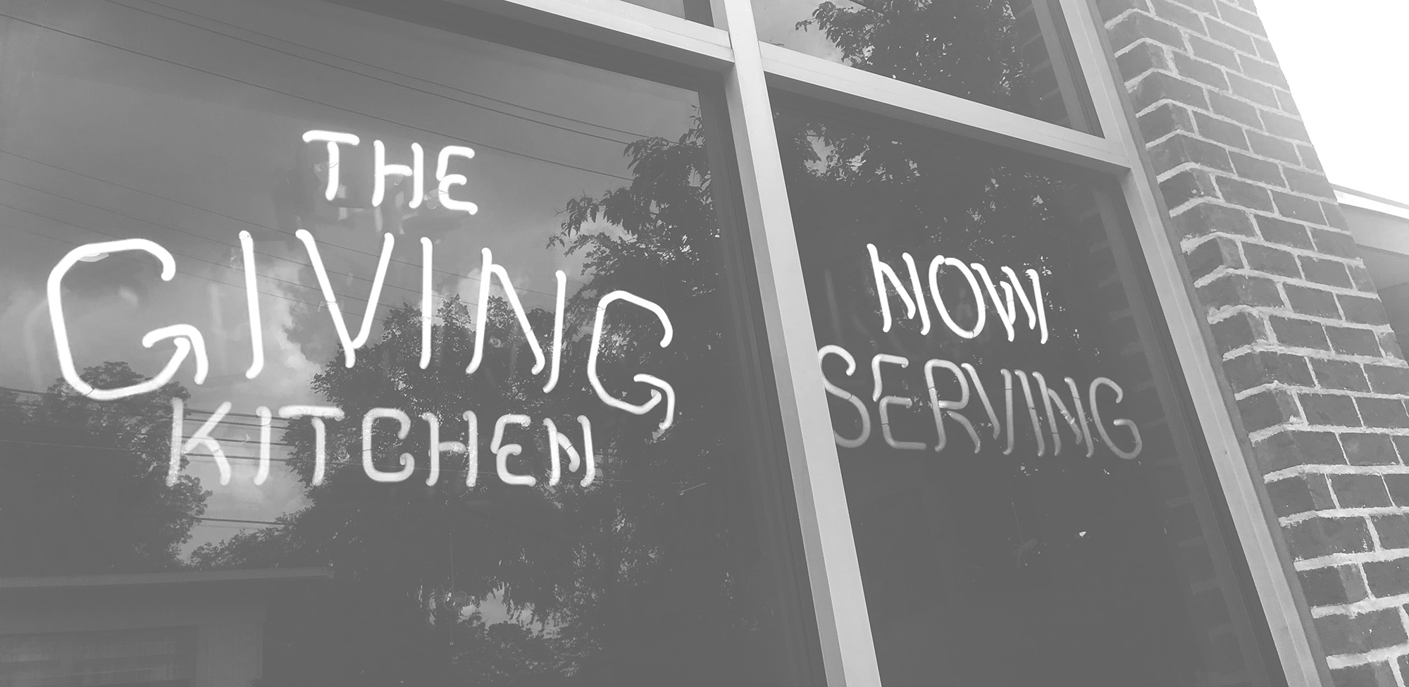 Giving Kitchen neon sign on the front of GK HQ