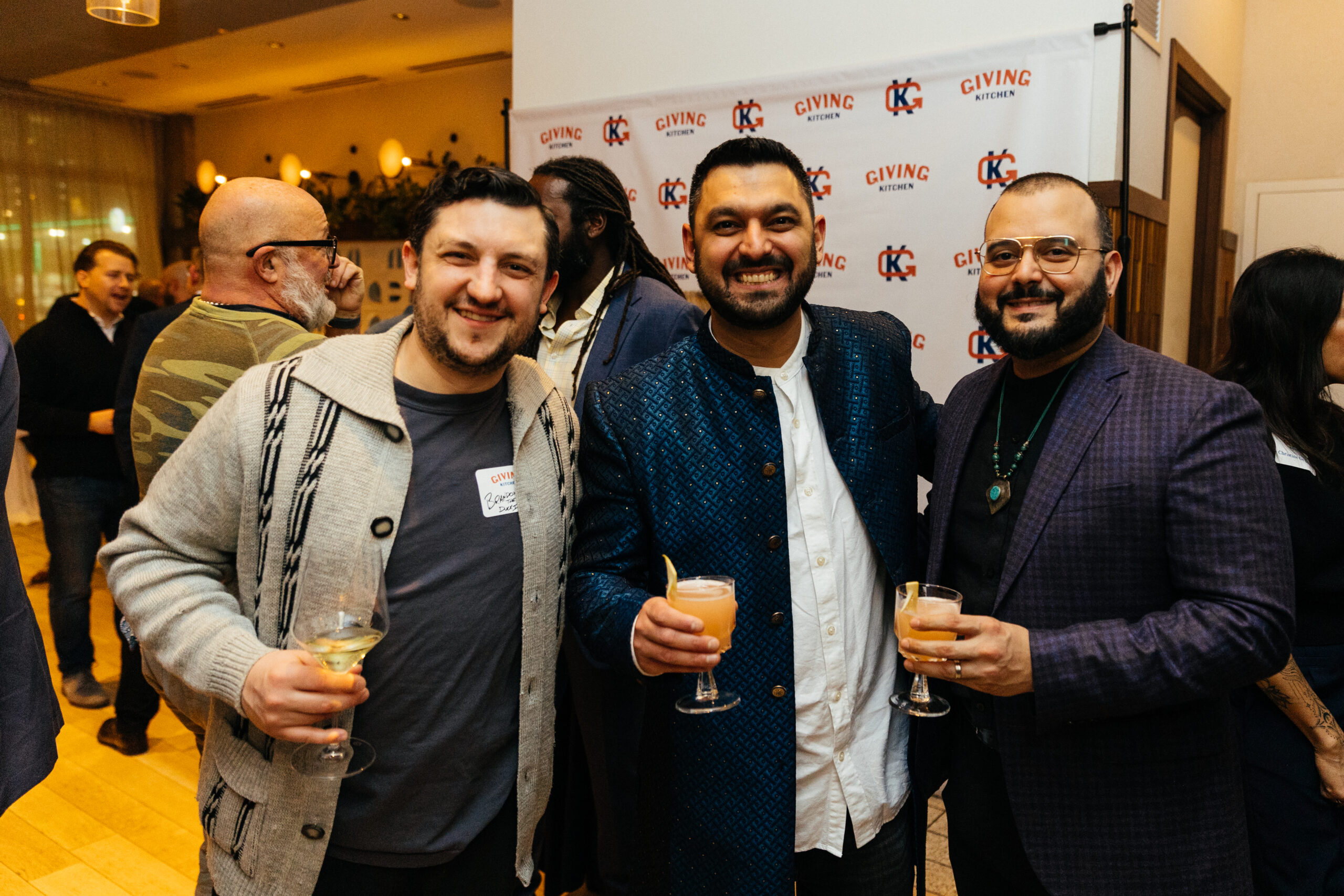 Guests pose at a Giving Kitchen reception