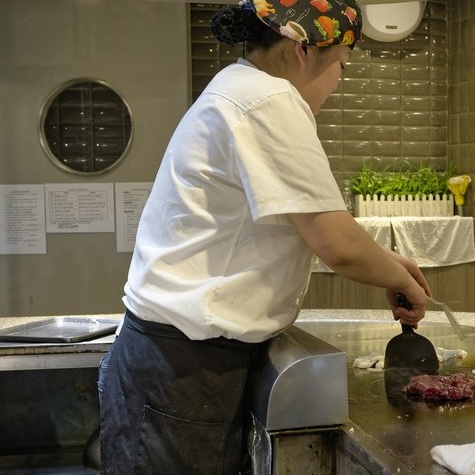 Fry cook working at a grill