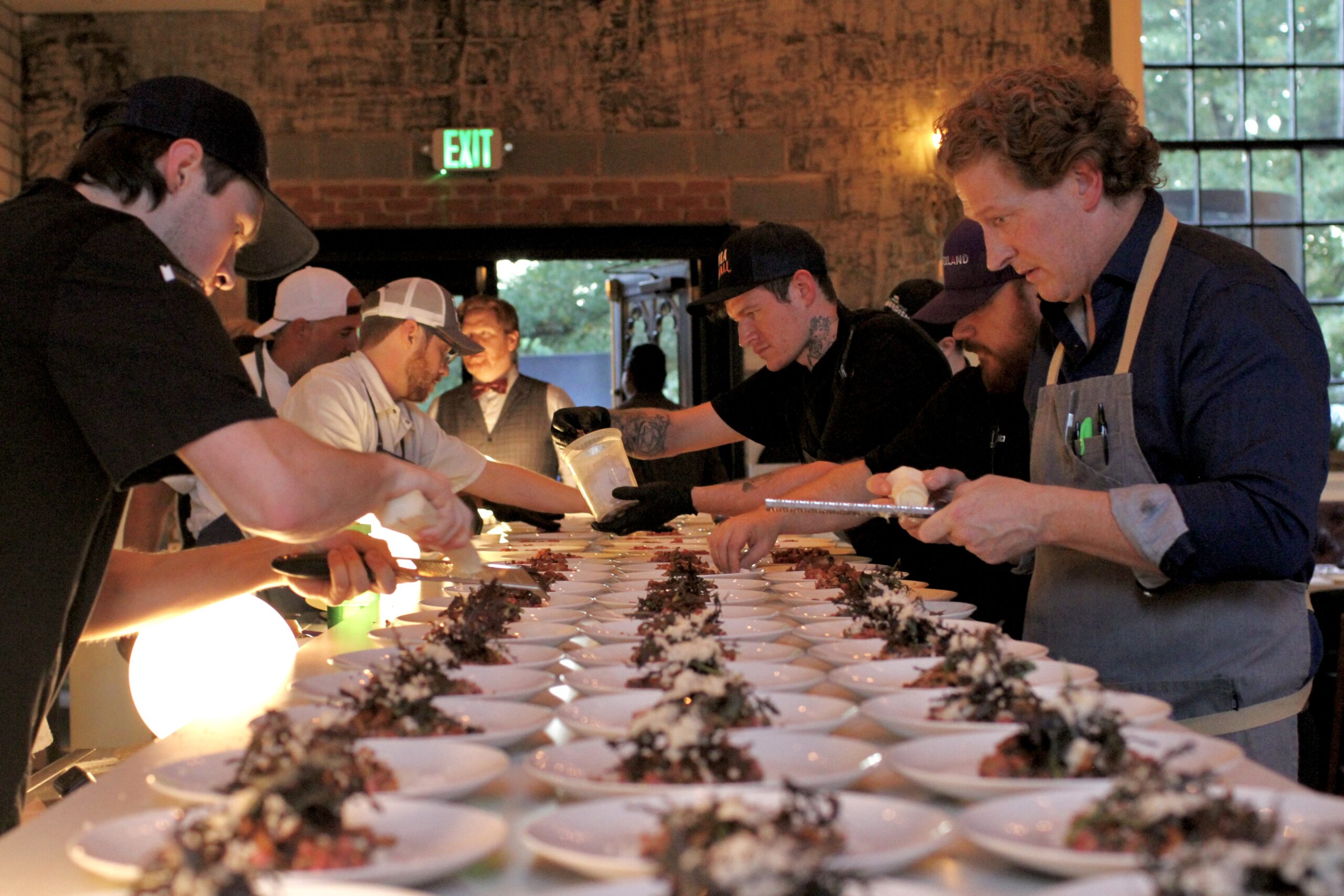 Chefs plate dishes at Charlotte Family Meal