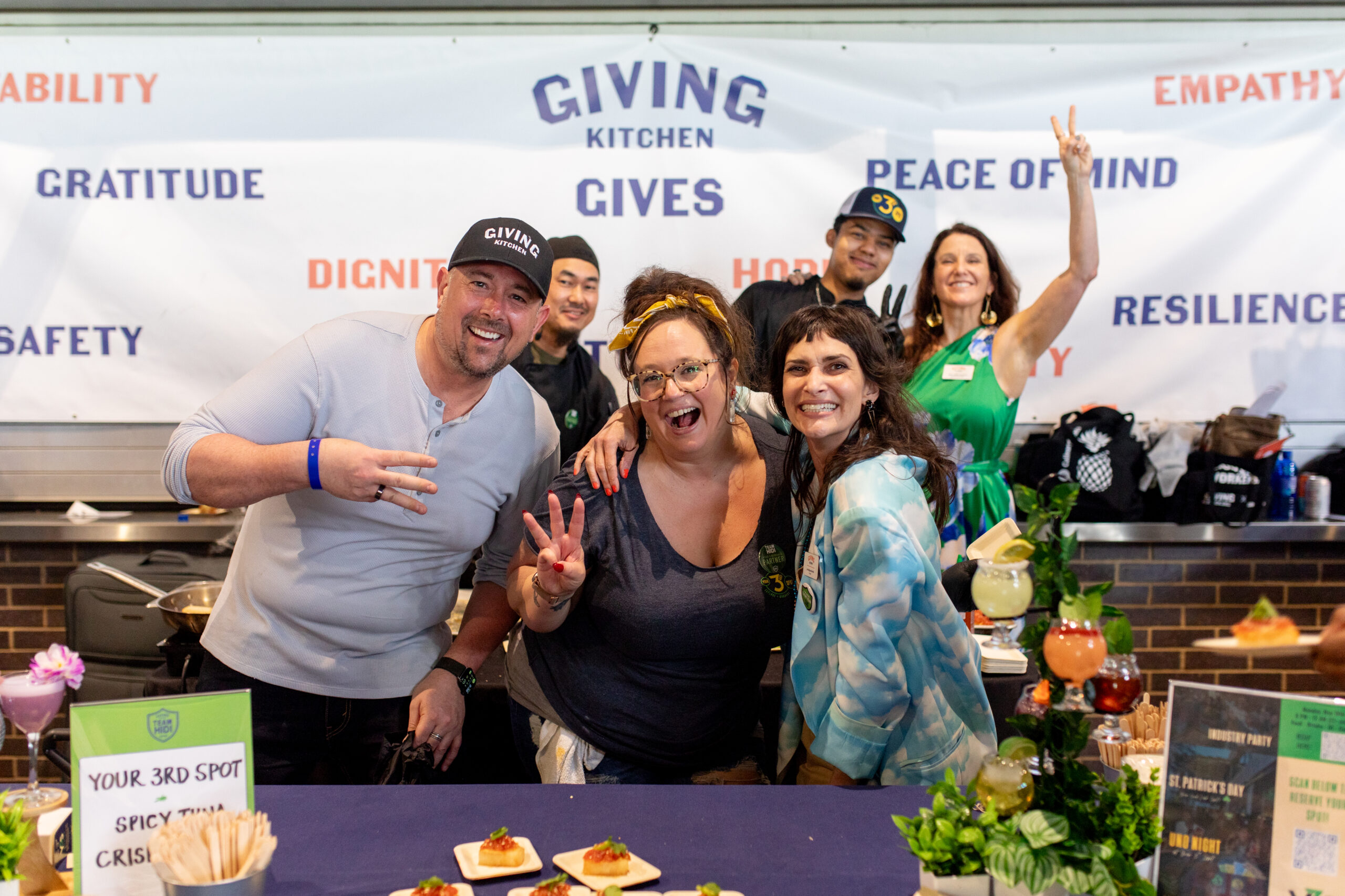 Giving Kitchen founder Jen Hidinger-Kendrick and CEO Allison Padilla-Goodman pose with the team from Your 3rd Spot at Team Hidi