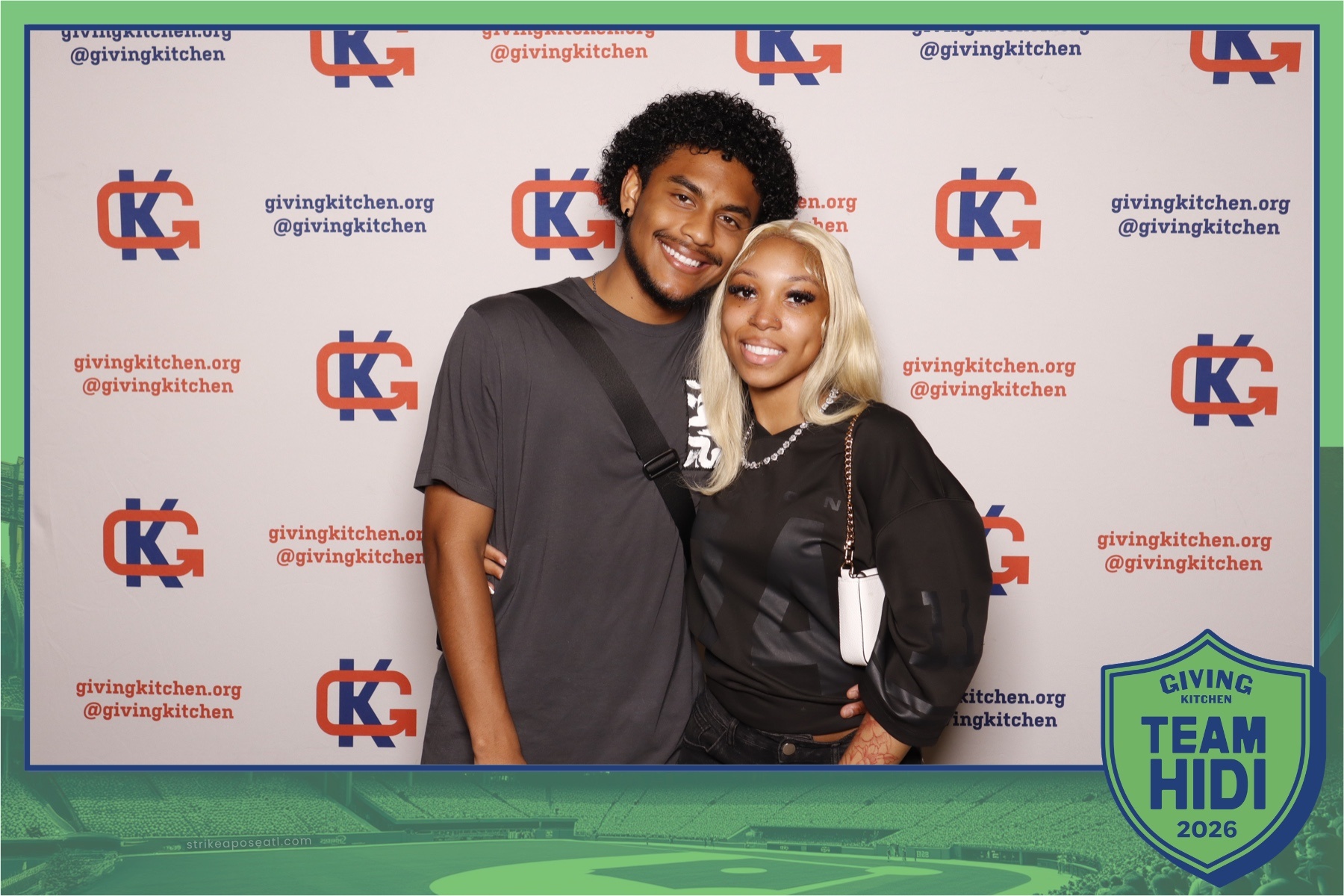 couple poses in the photobooth at Team Hidi 2026