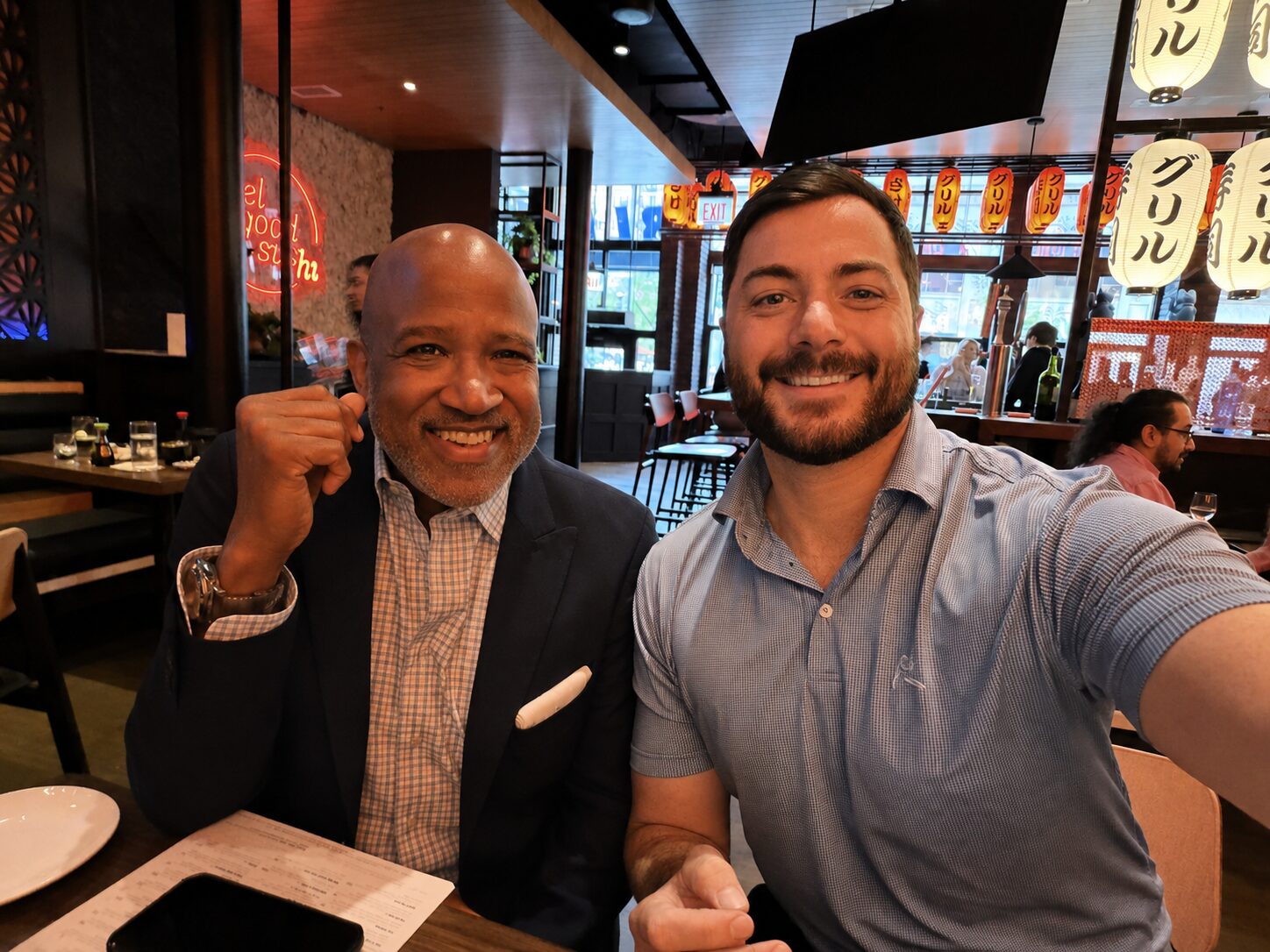 Rodrick Glass, Executive Vice President, Sales and Business Development, Creative Realities, Inc. and Benoit Sabourin, Chief Philanthropy Officer, Giving Kitchen enjoy a meal in Chicago during the National Restaurant Association Show 2026